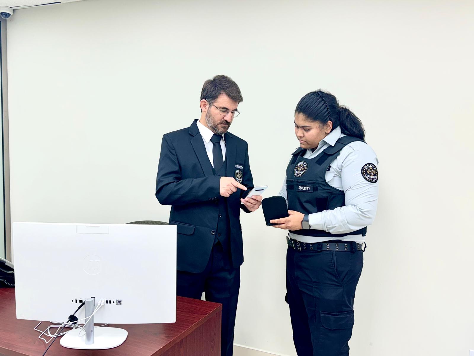 Delta Security supervisor and tactical guard reviewing assignment